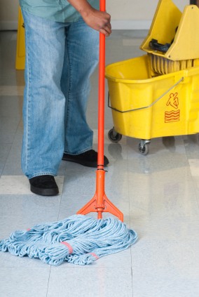 Hot Shot Commercial Services janitor in Bloomington, UT mopping floor.